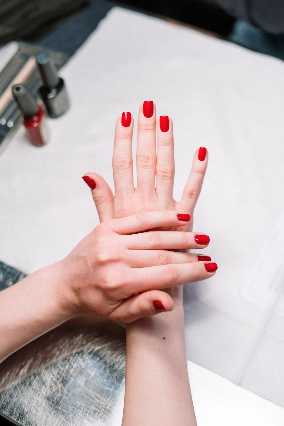 Finished red manicure by Signature Nails & Spa